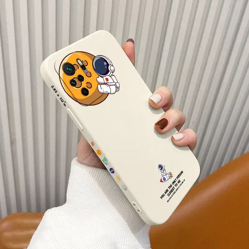 A person holding a phone case with a dog face on it