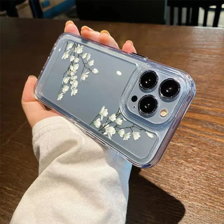 A person holding a phone case with flowers on it