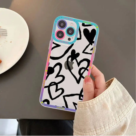 A person holding a phone case with graffiti on it