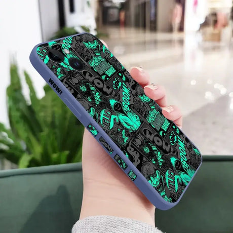 A person holding a phone case with a green and black pattern