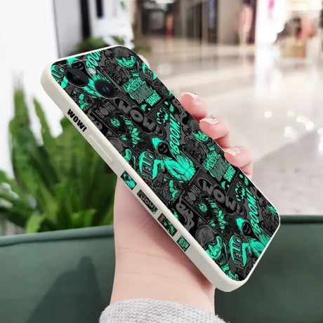 A person holding a phone case with a green and black pattern