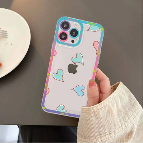 A person holding a phone case with a heart pattern