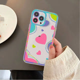 a person holding a phone case with a heart pattern