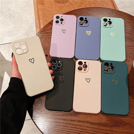a person holding a phone case with heart