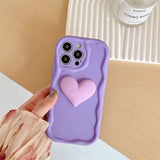 a person holding a phone case with a heart on it