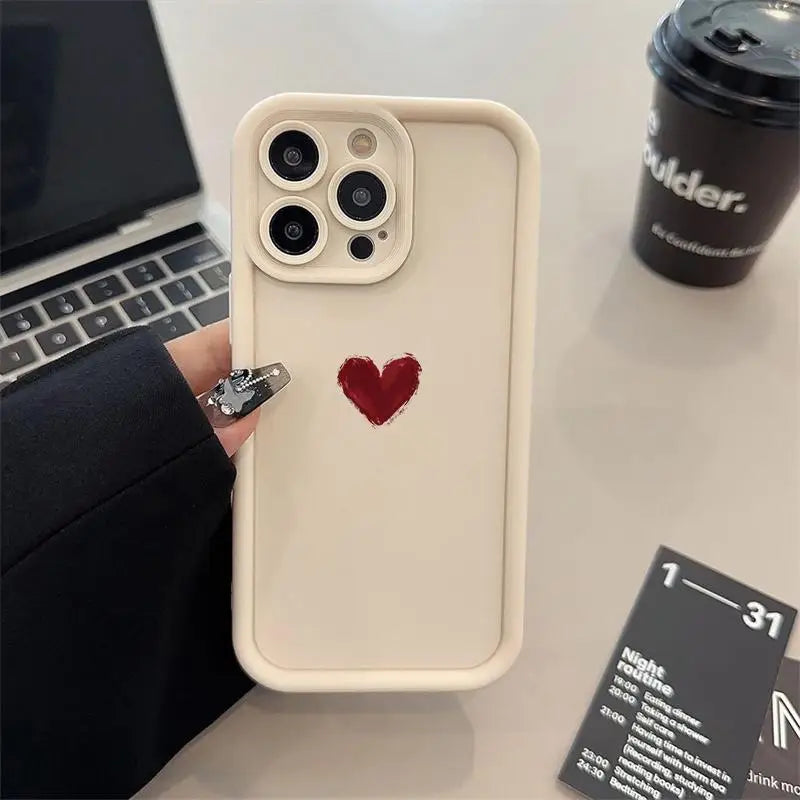 a person holding a phone case with a heart on it