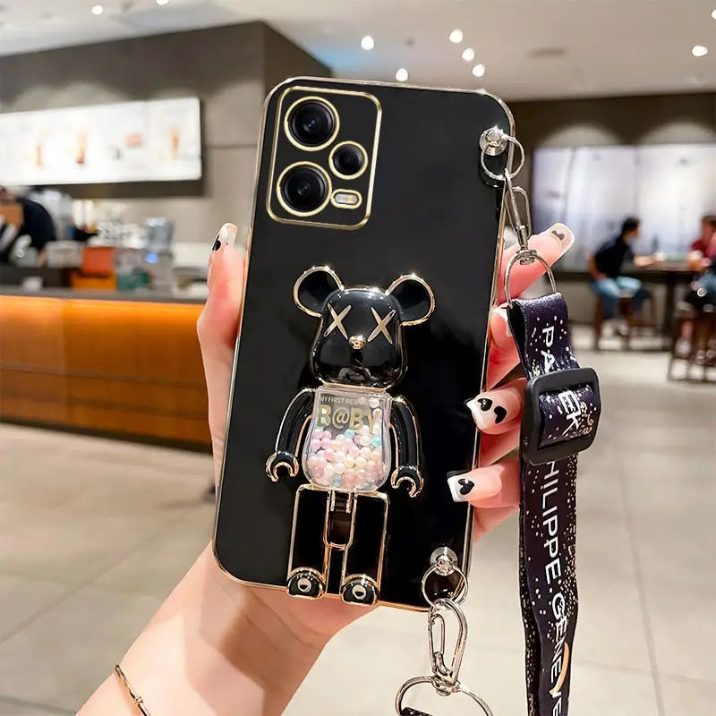 A person holding a phone case with a keychai