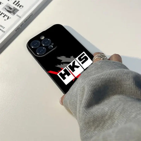 A person holding a phone case with the logo of the fox