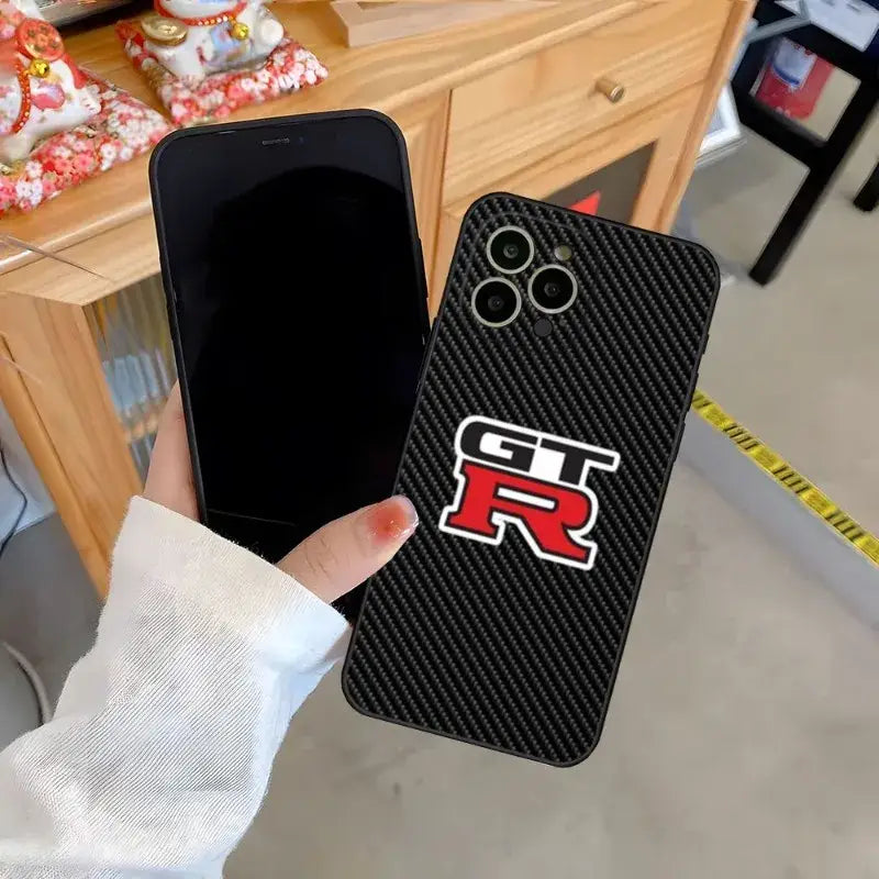 a person holding a phone case with a logo on it