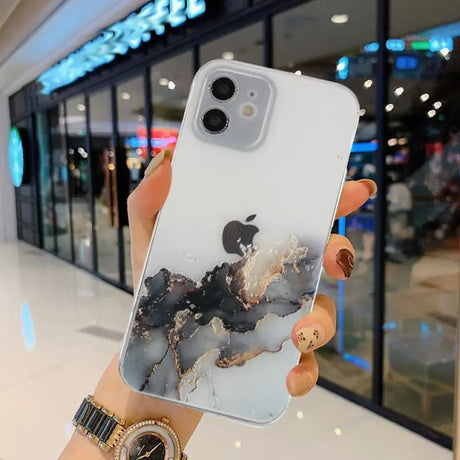 A person holding a phone case with a marble pattern