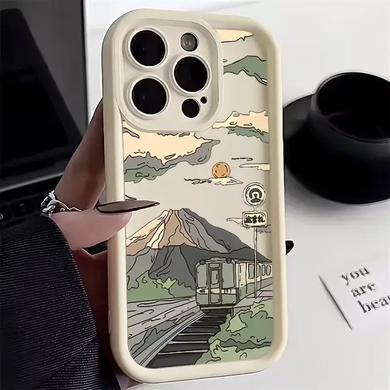 a person holding a phone case with a mountain scene