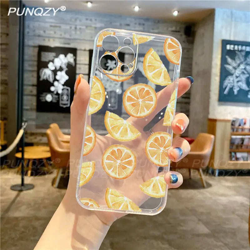 a person holding a phone case with orange slices
