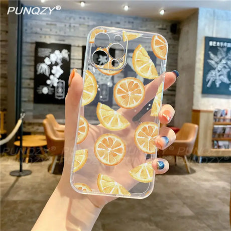 A person holding a phone case with orange slices