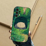 A person holding a phone case with a painting on it