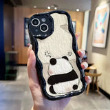 A person holding a phone case with a panda face on it