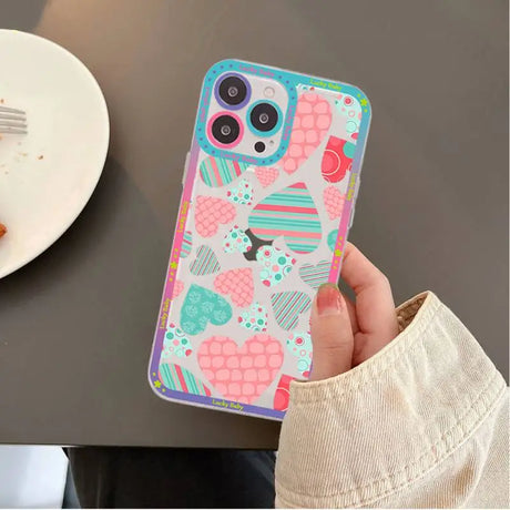 A person holding a phone case with a pattern on it