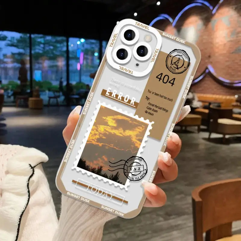 A person holding a phone case with a photo of a sunset