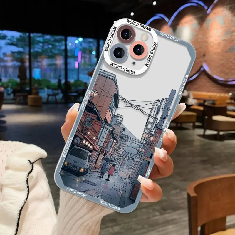 a person holding a phone case with a photo of a street scene