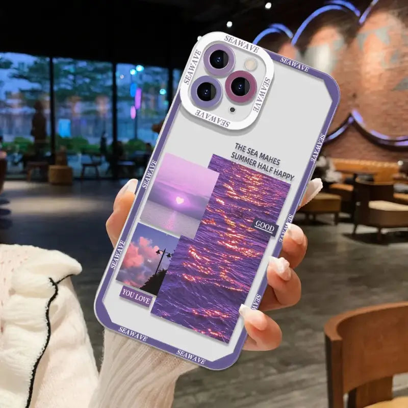 a person holding a phone case with a photo of a sunset