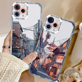 A person holding up a phone case with a picture of a city