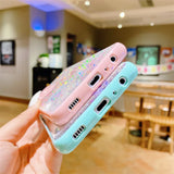 a person holding a phone case with a pink and blue case