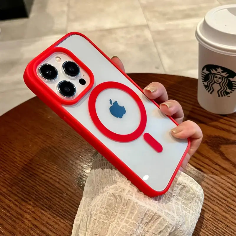 a person holding a phone case with a red apple logo