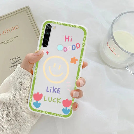 a person holding a phone case with a smiley face on it