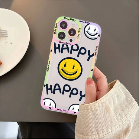 A person holding a phone case with smiley face