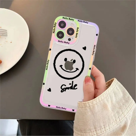 A person holding a phone case with a smiley face on it