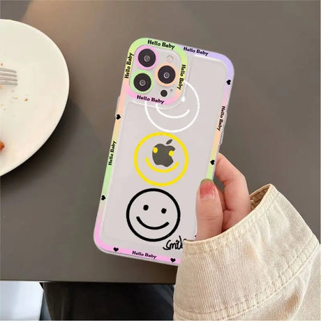 A person holding a phone case with smiley faces on it