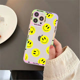a person holding a phone case with smiley faces on it