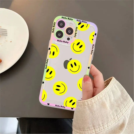 A person holding a phone case with smiley faces on it