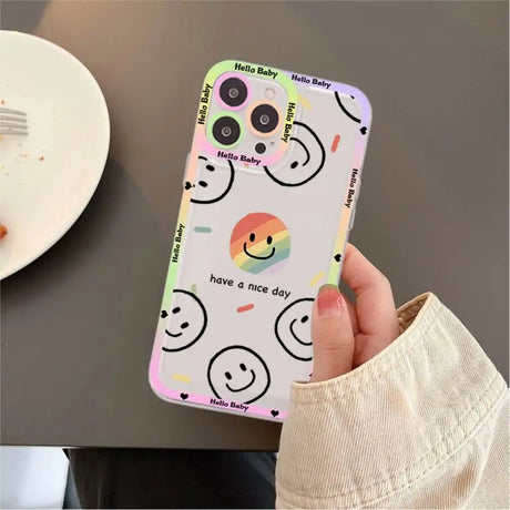 A person holding a phone case with a smiley face on it