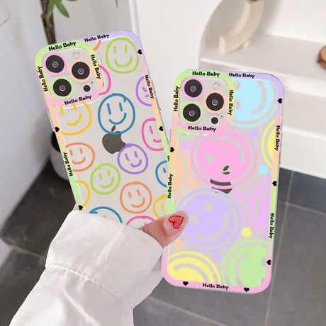 A person holding up a phone case with a smiley face