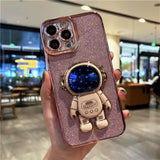 A person holding a phone case with a spaceman on it