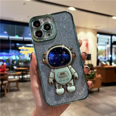 A person holding a phone case with a spaceman on it