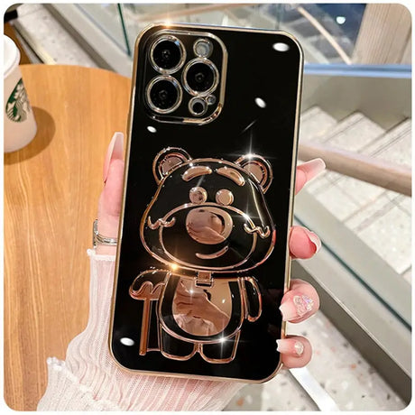 A person holding a phone case with a teddy bear