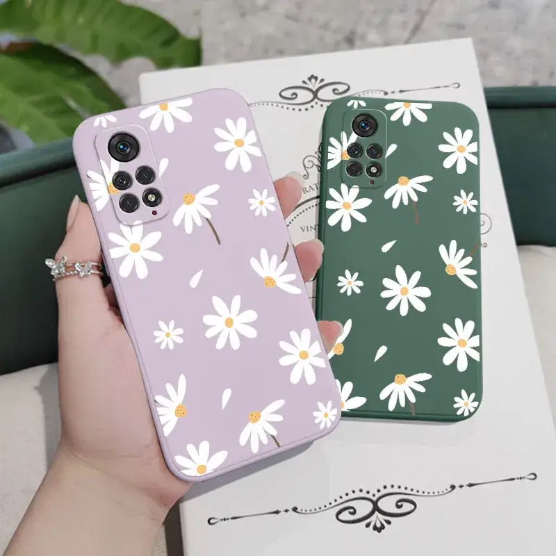 A person holding a phone case with white flowers on it