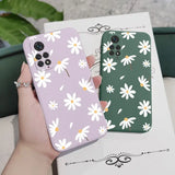 a person holding a phone case with white flowers on it