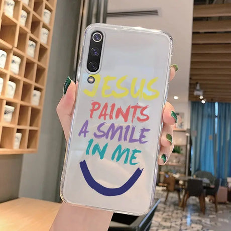 A person holding a phone case with the words’fuck, paint, smile ’