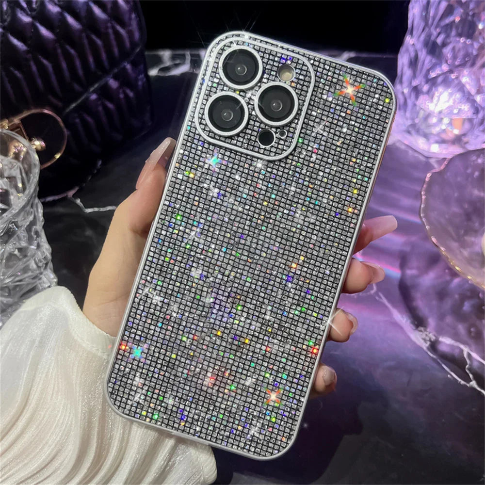 a person holding a phone with a diamond case on it