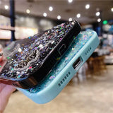 a person holding a phone with a glitter case