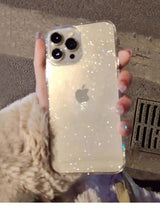 a person holding a phone with glitter on it