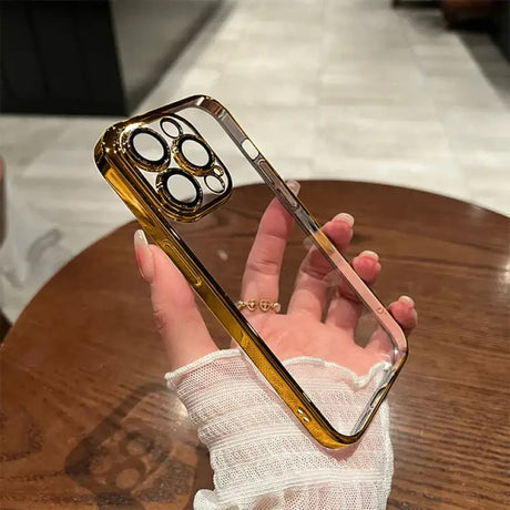 A person holding a phone with a gold case