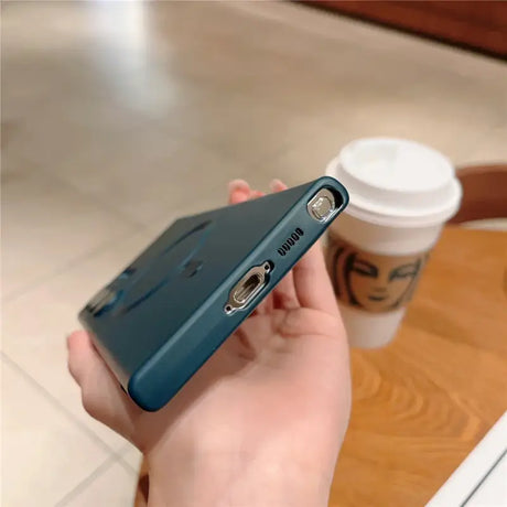 A person holding a phone in their hand