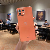 a person holding up a phone with a heart on it