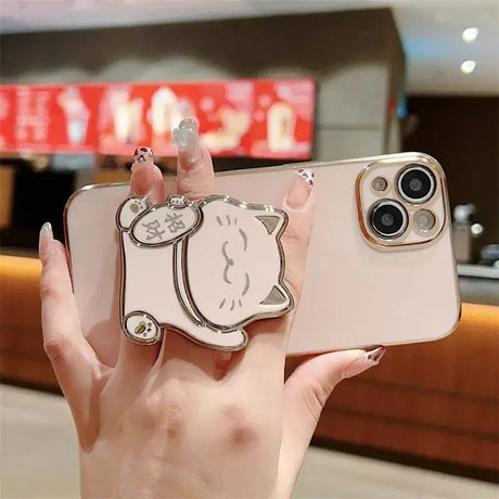 A person holding a phone with a hello kitty on it