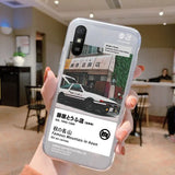 a person holding up a phone with a photo of a car