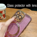 A person holding a phone with a pink glitter case