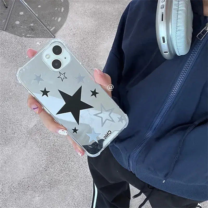 a person holding a phone with a star design on it